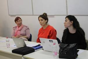 Women sitting at a table with laptops

Description automatically generated with medium confidence
