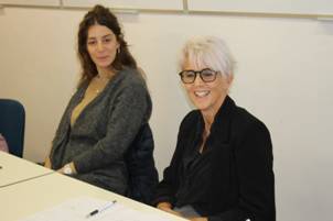 A couple of women sitting at a table

Description automatically generated with low confidence